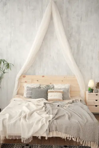 A Pallet Bed with White Canopy
