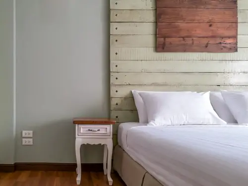 A Rustic Bed with Large Headboard