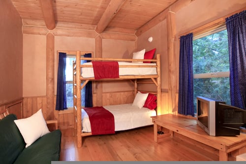 Wooden Rustic Bunk Bed in a Log Cabin Bedroom