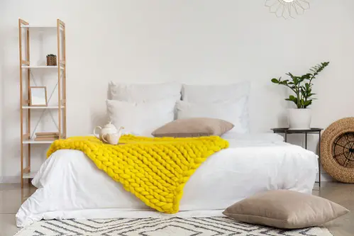 Farmhouse Bedrooms in Lemon Yellow with Knitted Blanket