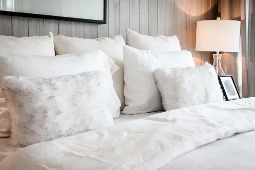 how to stop pillows from falling behind bed